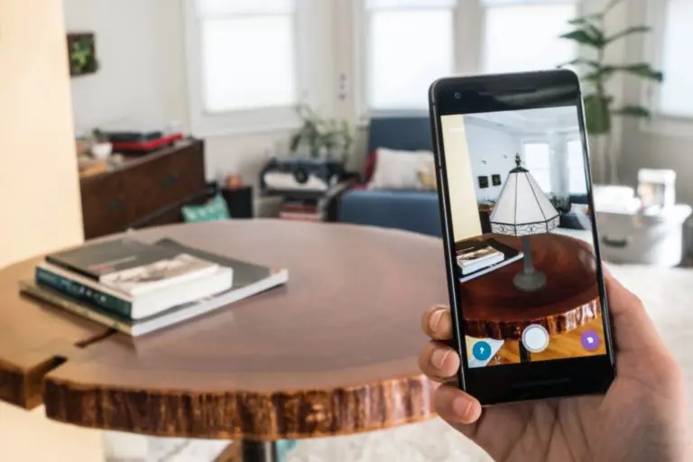 A phone shows how a light would look on a table using AR